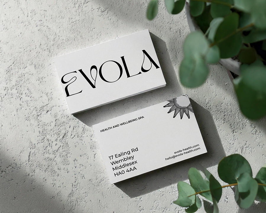 A beautiful contemporary business card pictured next to some greenery to represent health and wellbeing.