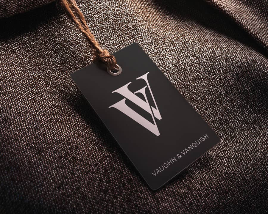 A swing tag for a high-end clothing company placed on top of a tweed jacket.