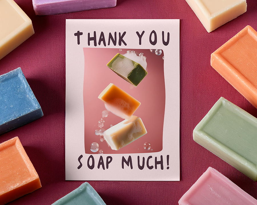 A double sided Thank you card for a soap company surrounded by colourful bars of soap.