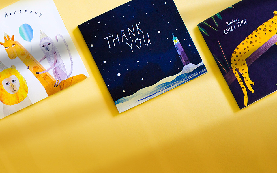 A collection of greetings cards all featuring different designs on a yellow background