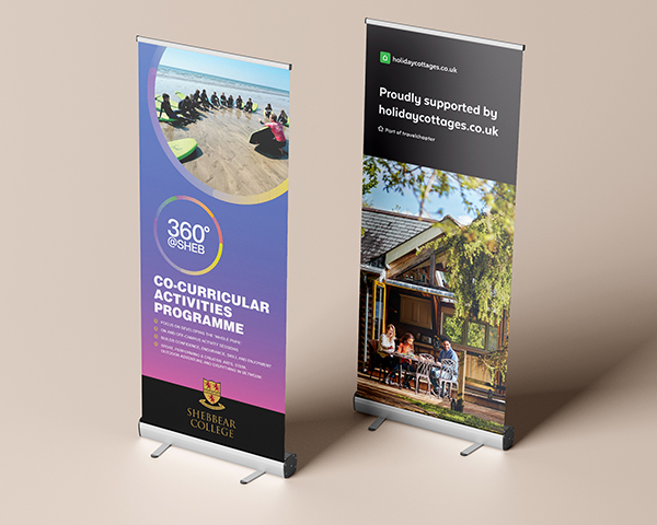 Two roller banners featuring vibrant graphics, ideal for trade shows, events, or promotional displays.